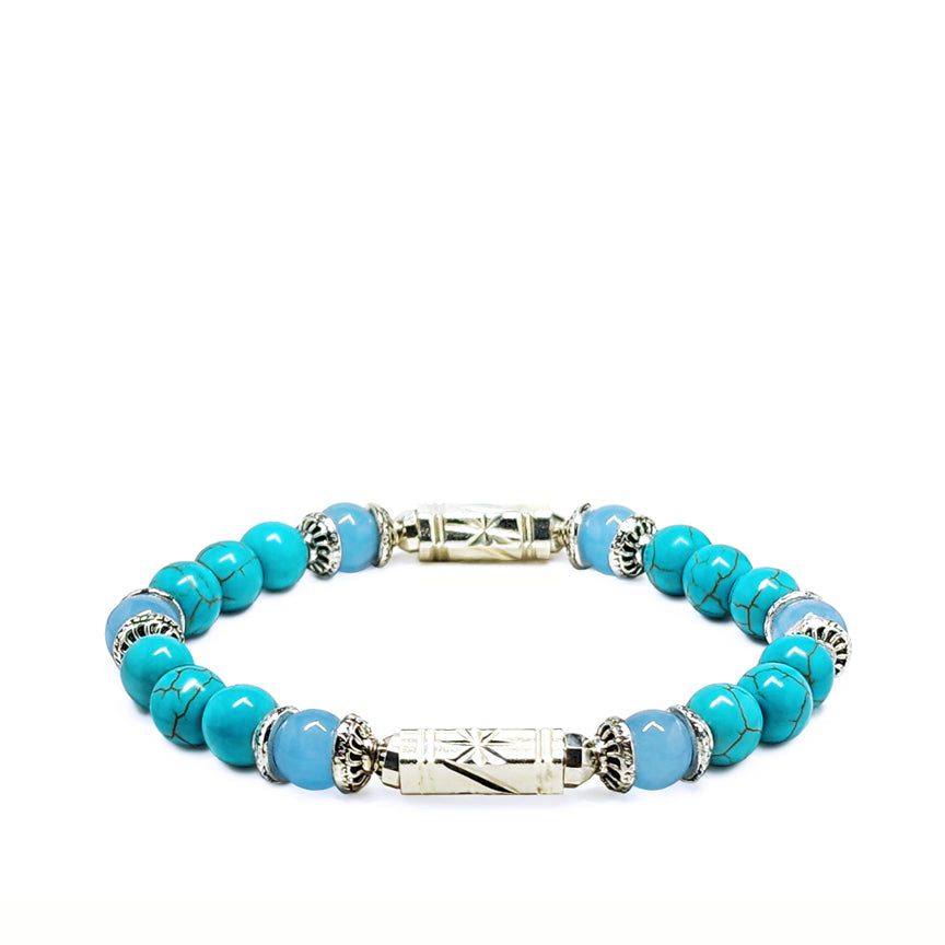 Turquoise howlite bracelet with aquamarine and silver laying on a white background