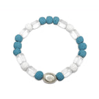 Blue lava and clear glass beads with silver accent floating over a white background