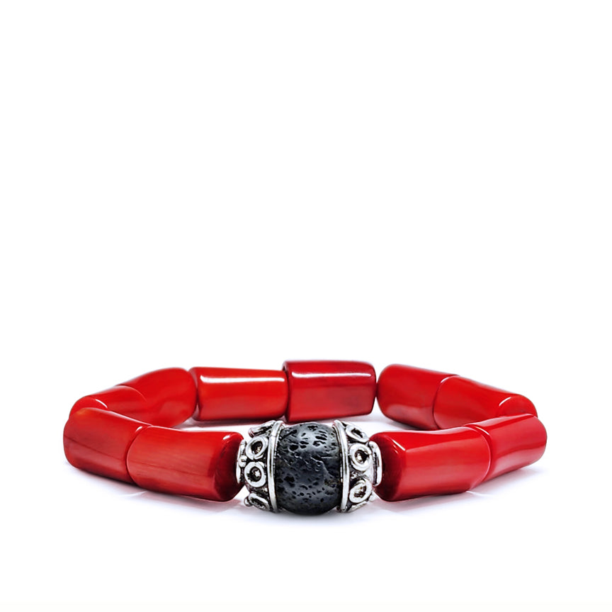 Red coral bracelet with black lava bead and silver laying on a white background
