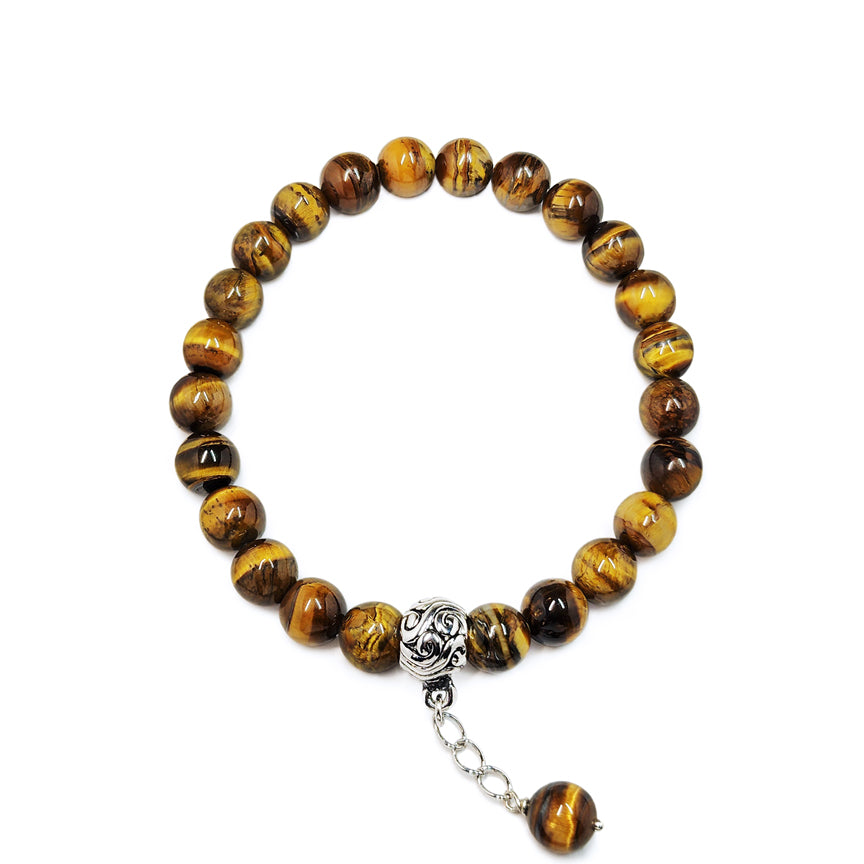 Tiger eye beaded bracelet with a silver chain and charm floating over a white background