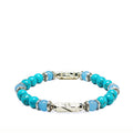 Turquoise howlite bracelet with aquamarine and silver laying on a white background