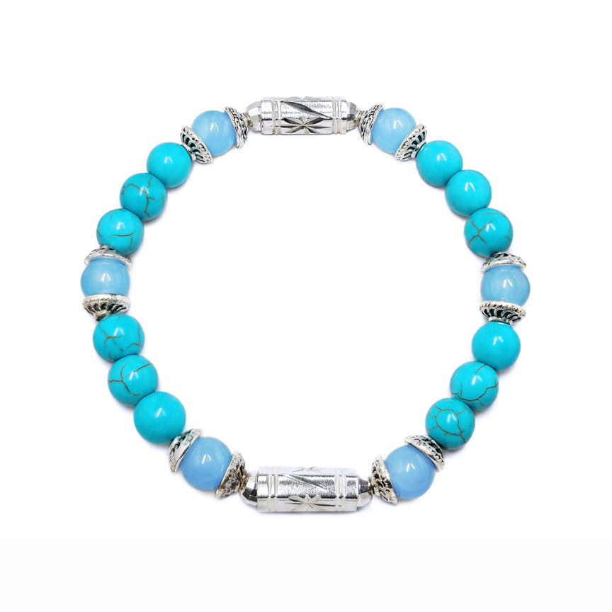 Turquoise howlite bracelet with aquamarine and silver floating over a white background
