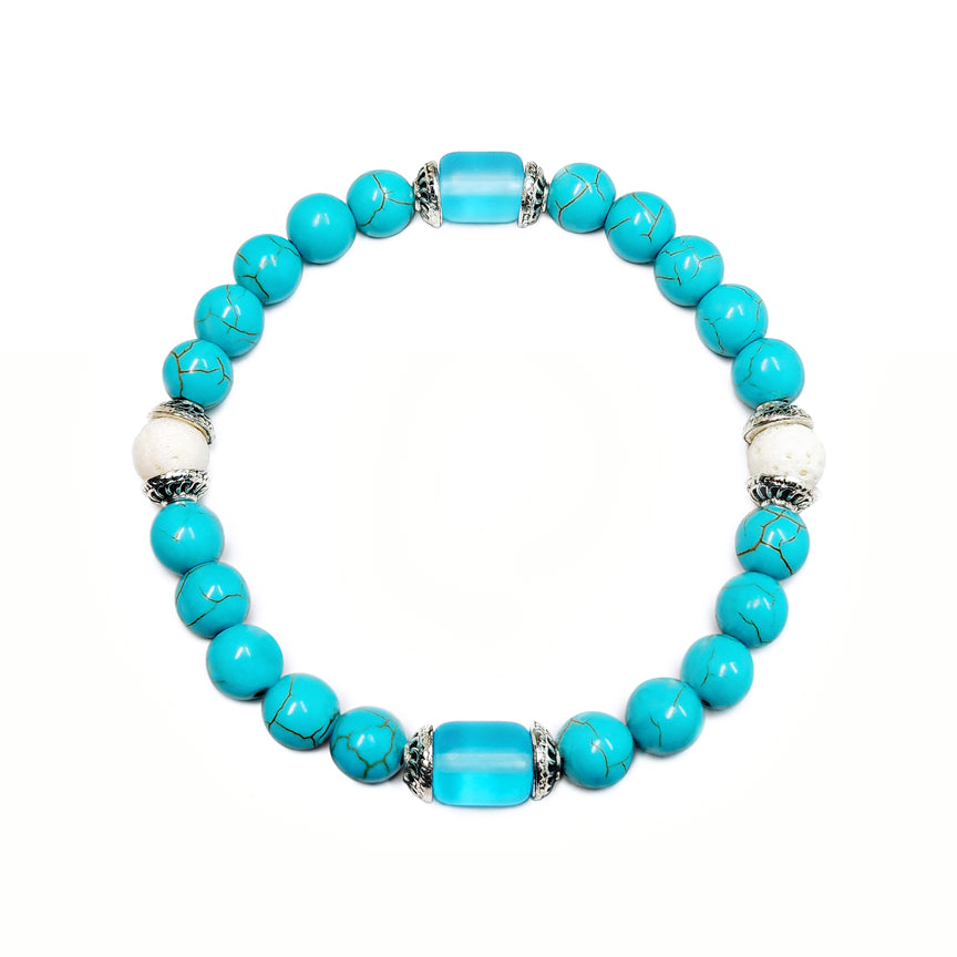 Turquoise howlite with blue glass and silver bracelet floating over a white background
