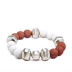 Two-Tone Red and white lava bracelet with alternating silver beads laying on a white background