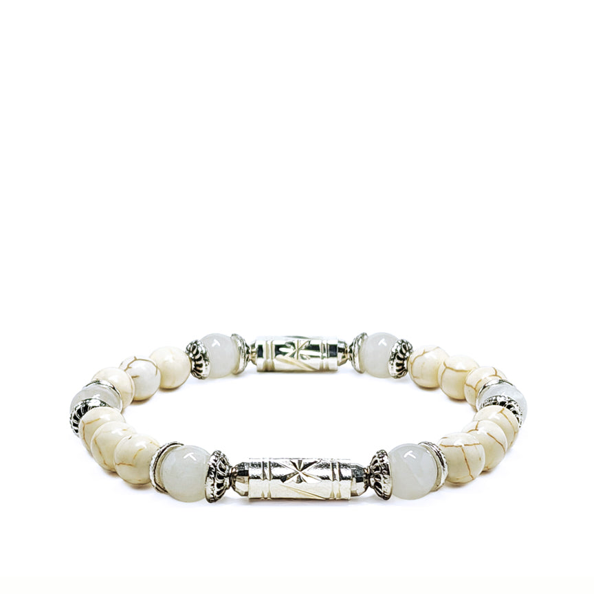White howlite bracelet with white jade and silver laying on a white background
