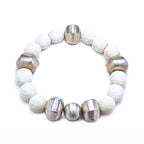 White lava bracelet with alternating silver beads floating over a white background